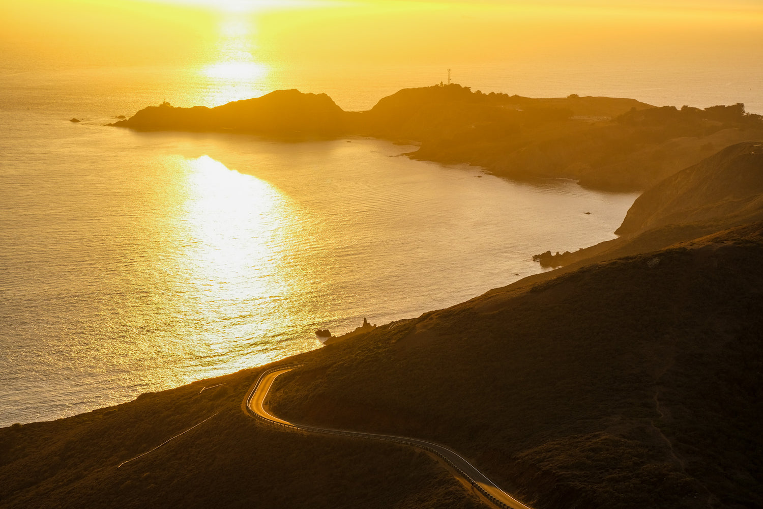 a coastal sunset in Marin County, California with a road for delivery and a spit going into the ocean